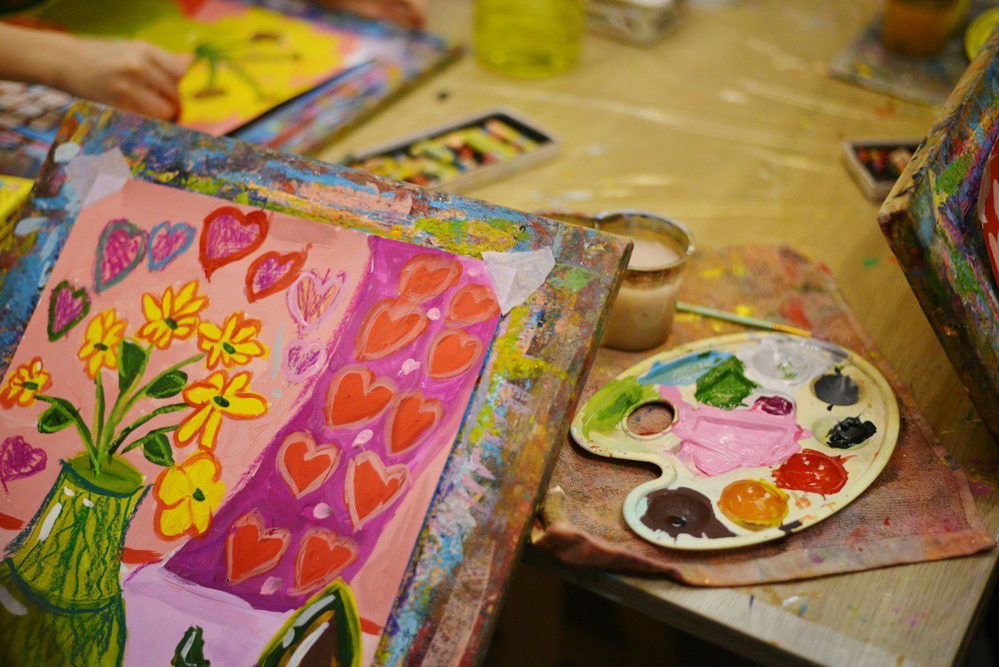 Colorful painting and art materials on a worktable